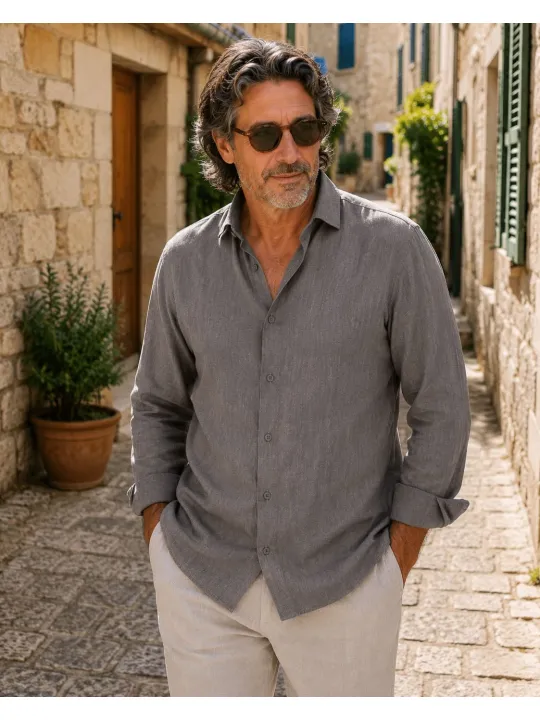 Man wearing a men's long sleeve taupe linen shirt by Luberone walking through the streets of Bonnieux
