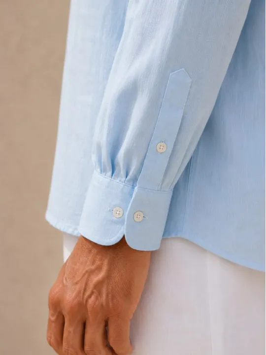 Buttoned cuff of the men's sky blue linen long sleeve shirt