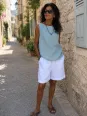 Women's sleeveless grey blue linen top Lauris worn in a Luberon village street