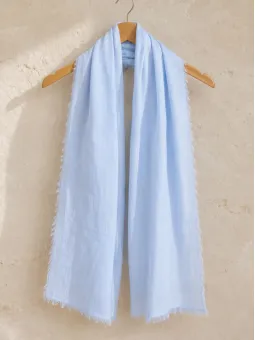 Light blue 100% linen scarf hanging on a wooden hanger