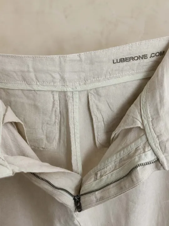 Inside tailoring detail of women's sand pleated linen trousers