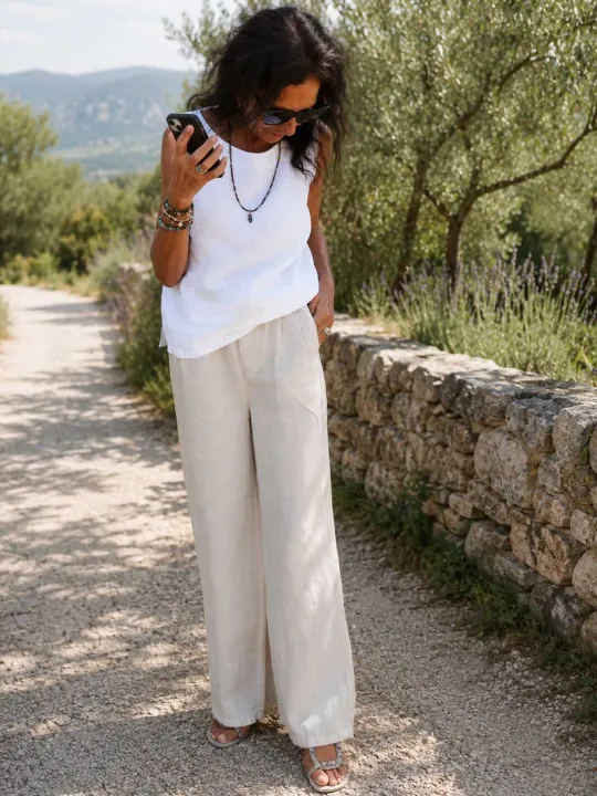 Women's sand pleated linen trousers worn in the Luberon