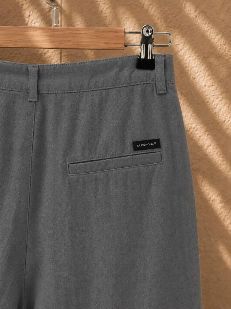 Rear pocket and label detail of women's pleated khaki linen trousers