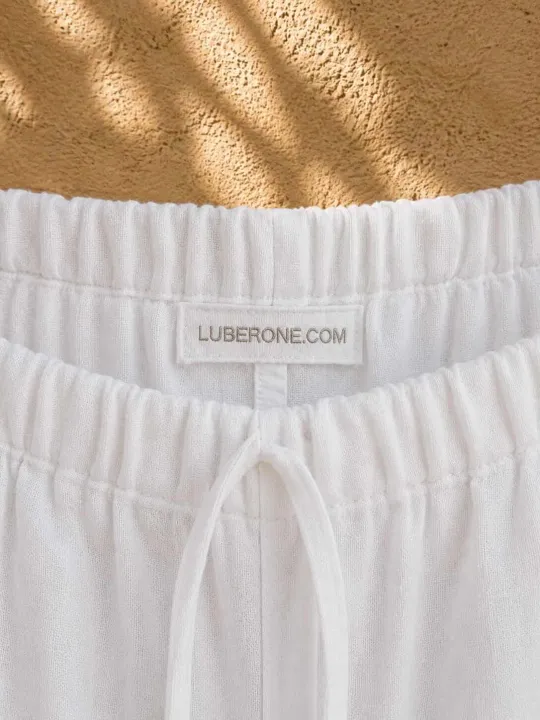 LUBERONE.COM label and elastic waistband detail on women's white linen trousers