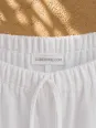 LUBERONE.COM label and elastic waistband detail on women's white linen trousers