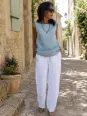 Women's white linen elastic waist trousers worn in a Luberon village