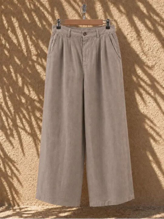 Women's beige pleated linen trousers on hanger