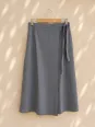 Women's taupe linen wrap skirt on wooden hanger