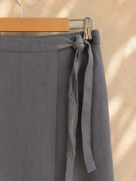 Close-up of the fastening on the women's taupe linen wrap skirt