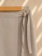 Tie fastening detail of the women's beige linen wrap skirt