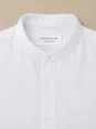 Collar and label detail of a white linen shirt for men Bonnieux