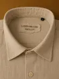 Collar and label detail of a men's beige linen shirt Bonnieux