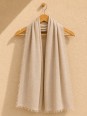 Sand 100% linen scarf hanging on a wooden hanger