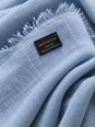 Close-up of the blue linen fabric and the ‘Made in France’ label