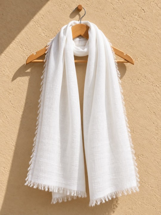 White 100% linen scarf hanging on a wooden hanger