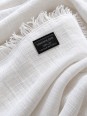Close-up of the white linen fabric and the ‘Made in France’ label