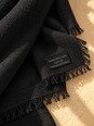 Close-up of the black linen fabric and the ‘Made in France’ label