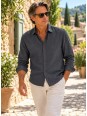 Man wearing an anthracite long-sleeved linen shirt in a village street in the Luberon, Provence